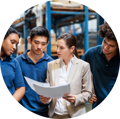 An employer reviewing benefits paperwork with employees